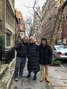 A group of people posing for a photo on a sidewalk Description automatically generated with low confidence